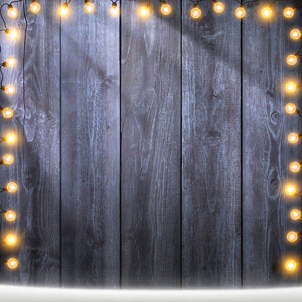 istock Christmas Lights on lit blank wooden background with snow 623453156