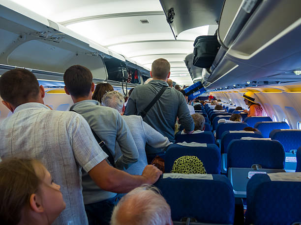Passengers expect exit the aircraft after landing Flight Simferopol-Moscow Moscow, Russia - June 15, 2016:  Passengers expect exit the aircraft after landing Flight Simferopol-Moscow airplane interior stock pictures, royalty-free photos & images