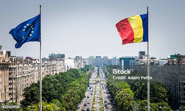 Romanian And European Union Flag Flying In Bucharest Romania Stock Photo - Download Image Now