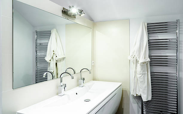 istock Modern Bathroom With Faucets On White Cabinet 623455270