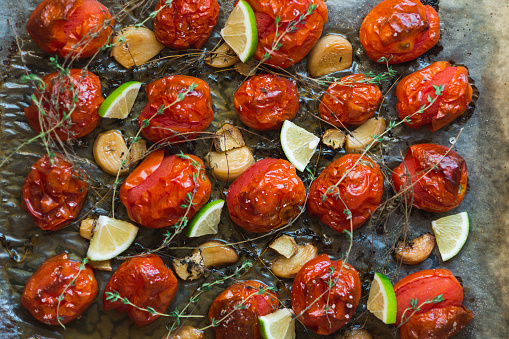 Baked tomatoes with thyme, garlic, lime  and olive oil