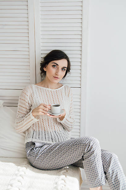 istock Girl drinking coffee and a croissant in bed 623456714