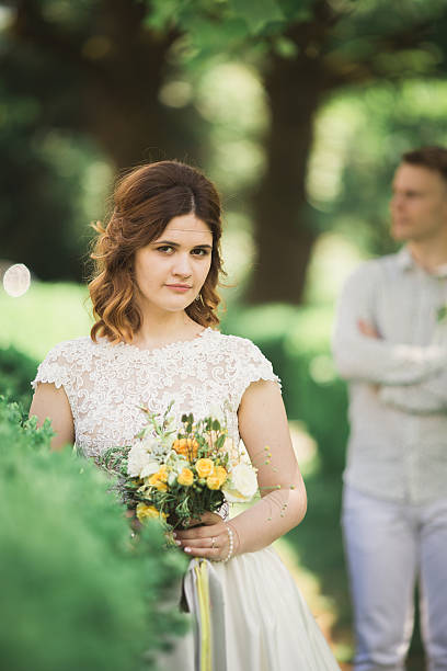 istock Bride posing and smiles while groom waits on the background 623456846