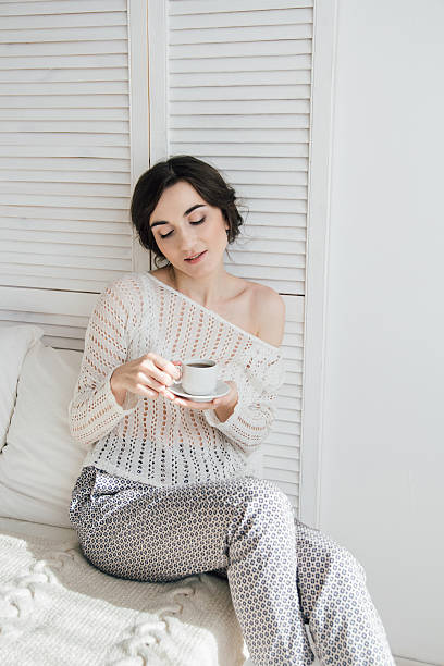 istock Girl drinking coffee and a croissant in bed 623457124