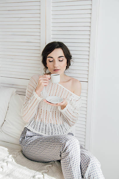 istock Girl drinking coffee and a croissant in bed 623457518