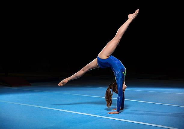 portrait of young gymnasts competing in the stadium portrait of young gymnasts competing in the stadium, retouched gymnastics stock pictures, royalty-free photos & images