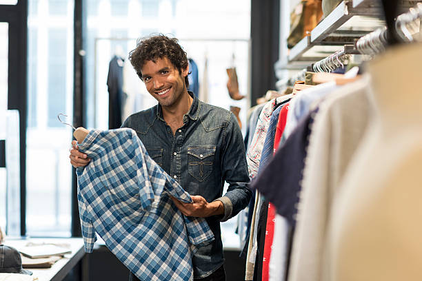 istock Man bought shirt in a fashionable shops. Looking at camera 623459112