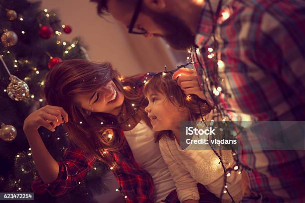 Fun With Christmas Lights Stock Photo - Download Image Now - Christmas, Family, Decorating