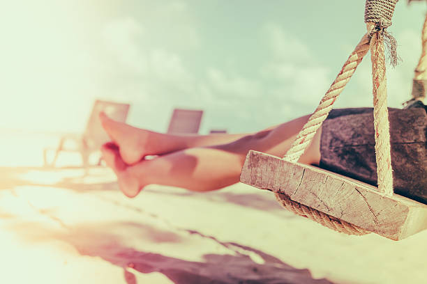 Legs of a woman on a swing - Filtered image processed vintage effect