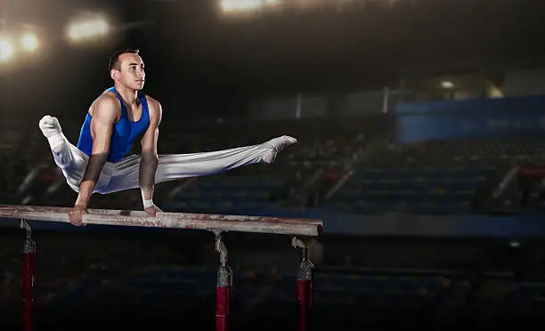 portrait of young man gymnasts competing in the stadium