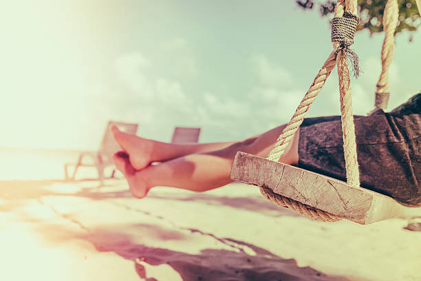 Legs of a woman on a swing - Filtered image processed vintage effect
