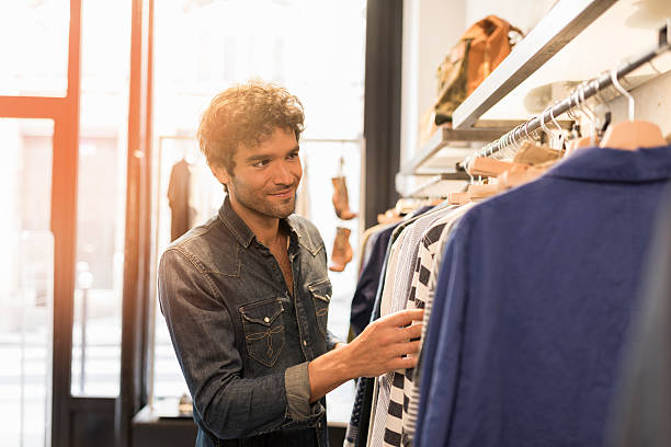 istock Man makes shopping in clothing store 623473502