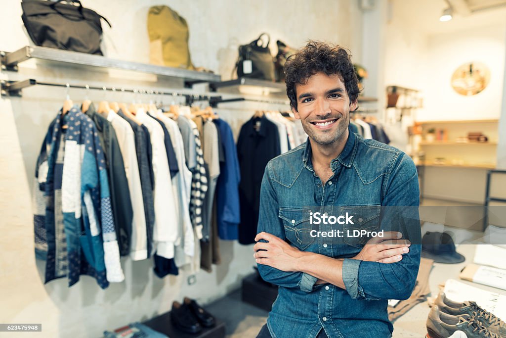 Portrait of cheerful owner in clothing store. Looking at camera - Royaltyfri Affär Bildbanksbilder