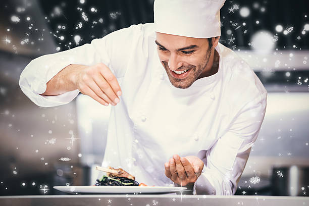 Snow falling against chef sprinkling spices on dish