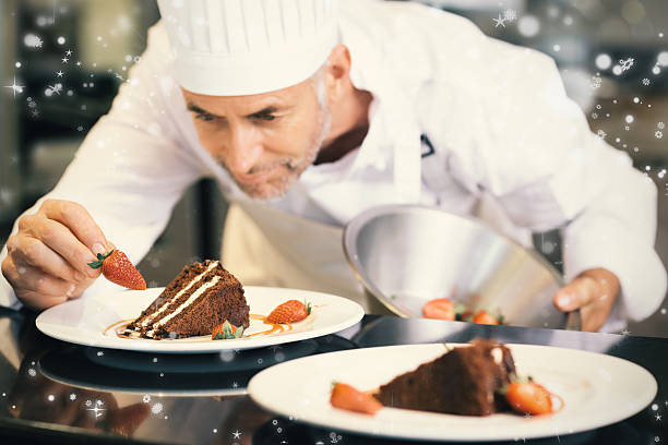 istock Snow falling against concentrated male pastry chef decorating dessert 623479992