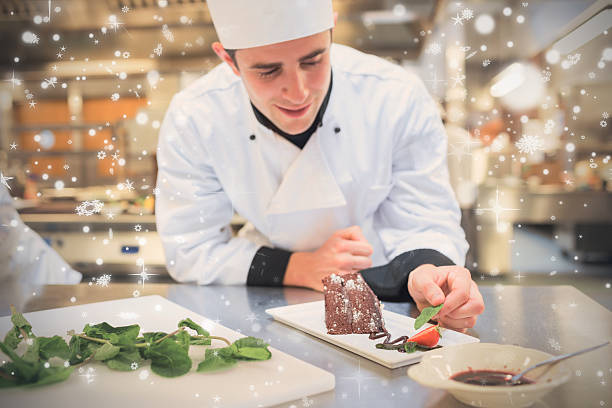 istock Snow falling against cheerful chef putting mint with his dessert 623480194