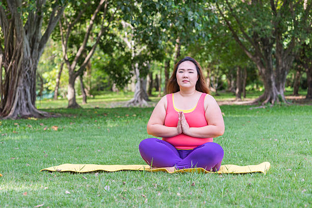 istock Beautiful fat woman doing yoga. 623483186