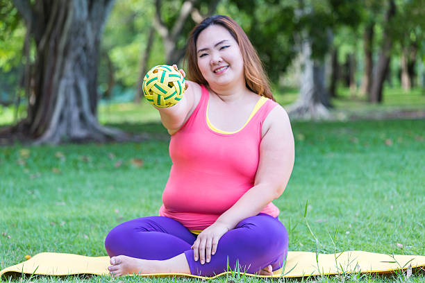 beautiful fat woman playing with rattan  ball. - sepaktakraw imagens e fotografias de stock