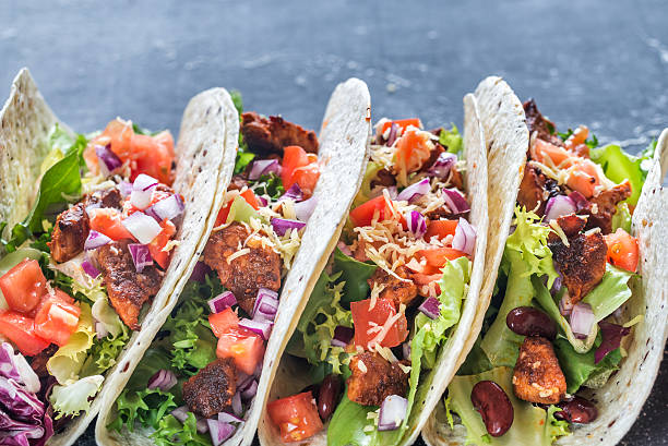 istock Four mexican tacos on a black background 623483544