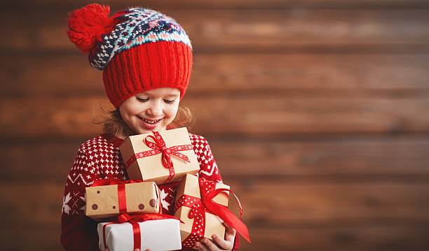 szczęśliwa dziewczynka z prezentem świątecznym - christmas child gift holiday zdjęcia i obrazy z banku zdjęć