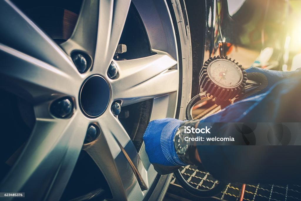 Car Tire Pressure Check Car Tire Pressure Check in the Auto Service Garage. Car Stock Photo