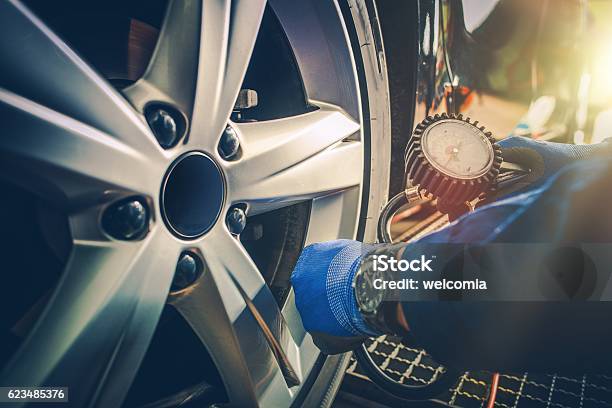 Car Tire Pressure Check Stock Photo - Download Image Now - Car, Horizontal, Land Vehicle