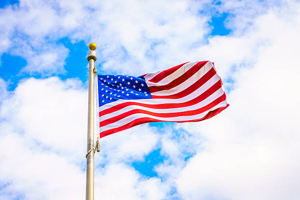 istock Low Angle View Of American Flag Against Cloudy Sky 623486196