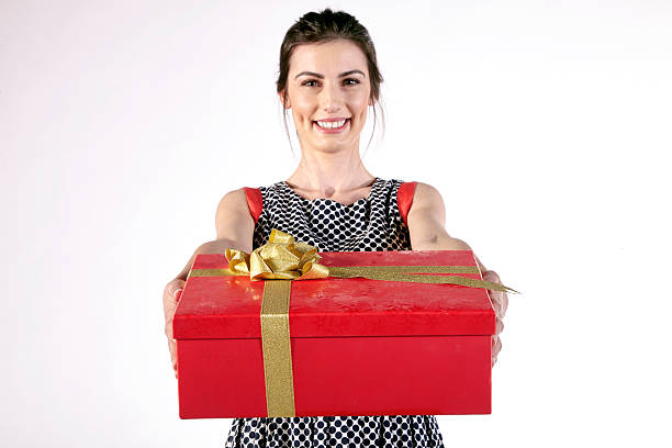 istock Young woman offering red gift box 623487822