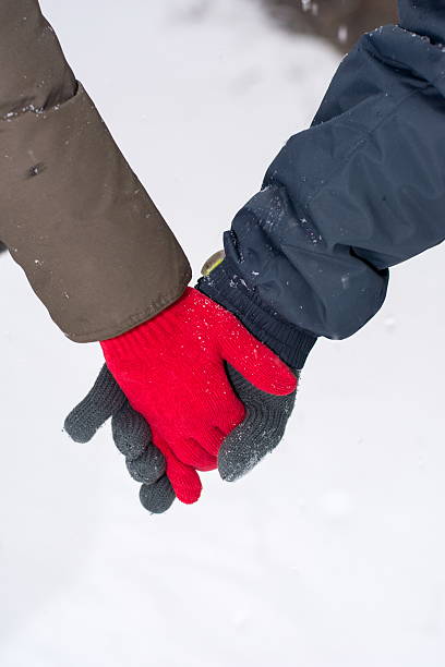 istock Couple holding hands in snow covered park 623488124