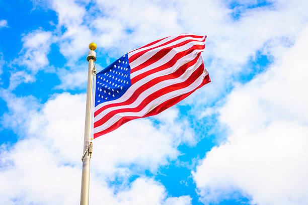 istock Low Angle View Of American Flag Against Cloudy Sky 623489410