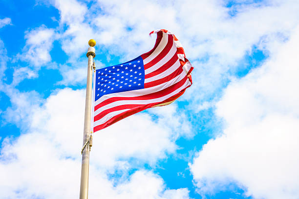 istock Low Angle View Of American Flag Against Cloudy Sky 623489586