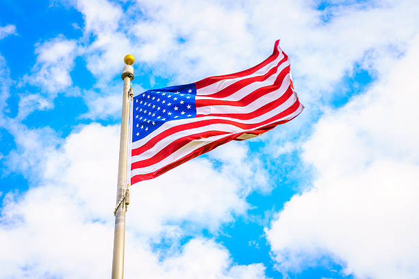 istock Low Angle View Of American Flag Against Cloudy Sky 623489688
