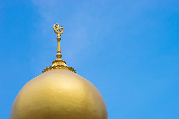 istock Islamic religion crescent moon sign on mosque with blue sky 623497644