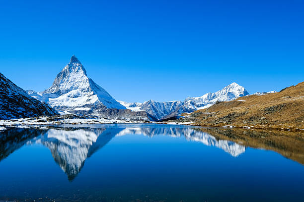 Reflection of Matterhorn in lake during autumn,zermatt, Switzerland Reflection of Matterhorn in lake during autumn,zermatt, Switzerland pennines photos stock pictures, royalty-free photos & images