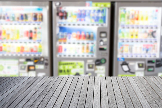 Empty top wooden table and blurred image of vending machine