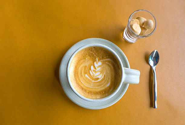 istock Cup of latte coffee on yellow Leather table 623500234