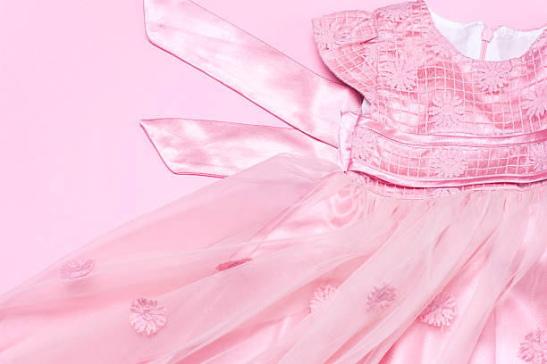 istock Clothes for baby girl on a pink background. Copy space 623502578