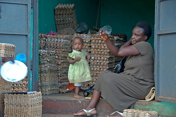Mother and child in there shop selling eggs. stock photo