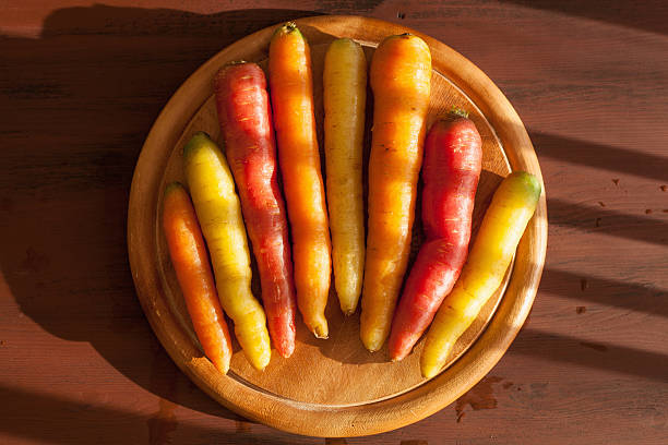 istock raw colorful carrot vegetable on wooden background 623503610