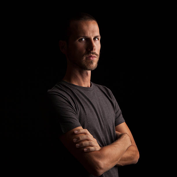 istock portrait of a handsome young man on black background 623505606