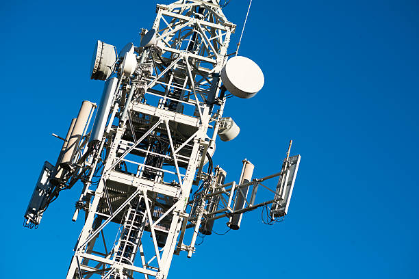 Communication tower against blue sky Communication tower against blue sky parabola stock pictures, royalty-free photos & images