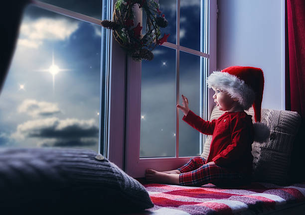istock baby girl sitting by the window 623506436