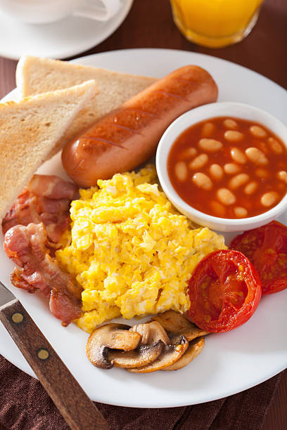 istock full english breakfast with scrambled eggs, bacon, sausage, bean 623506542
