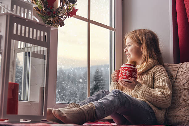 istock girl sitting by window 623506722