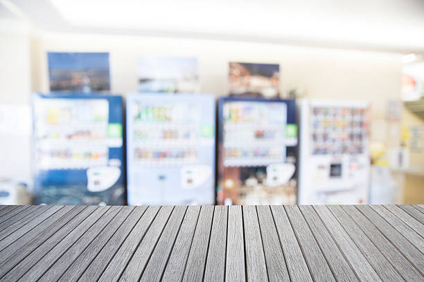 istock Empty top wooden table and blurred image of vending machine 623506882