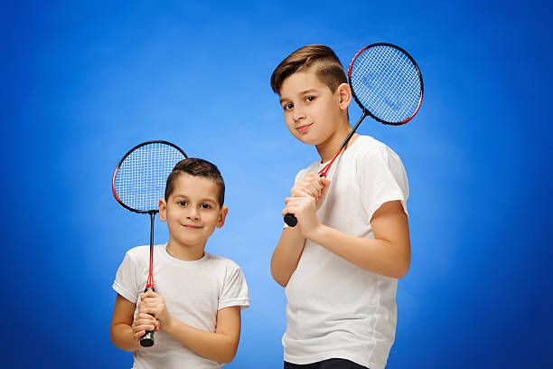 istock The two boys with badminton rackets outdoors 623507846