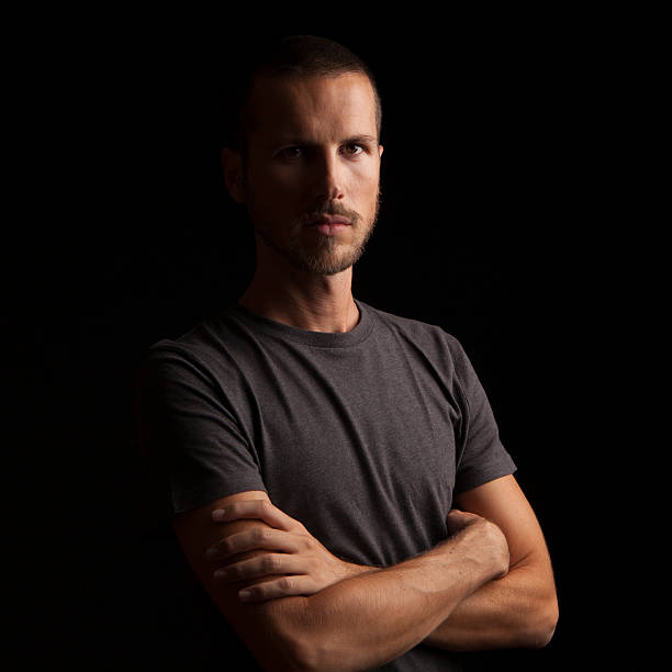 istock portrait of a handsome young man on black background 623507960
