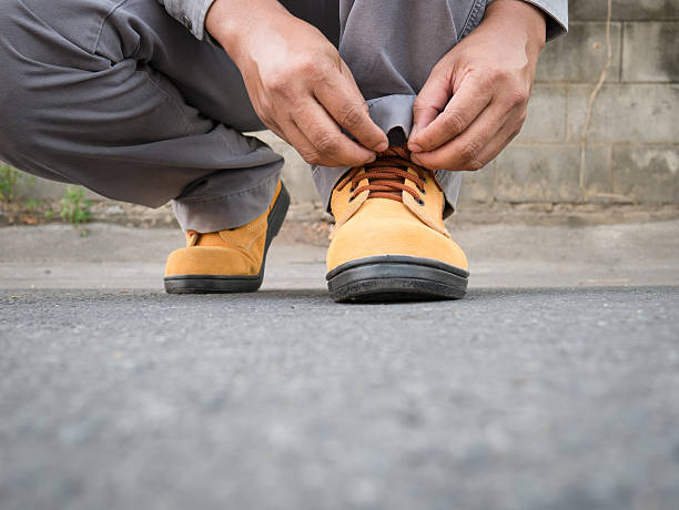 istock Man wears safety shoes on street 623509042