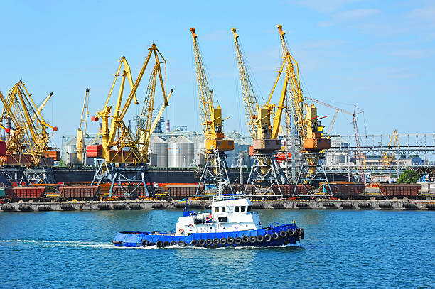 istock Tugboat and port cargo crane 623511456