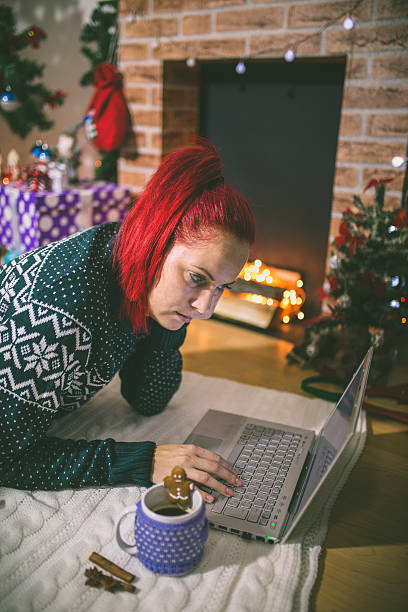 istock Lonely woman browsing internet on Christmas eve 623514226